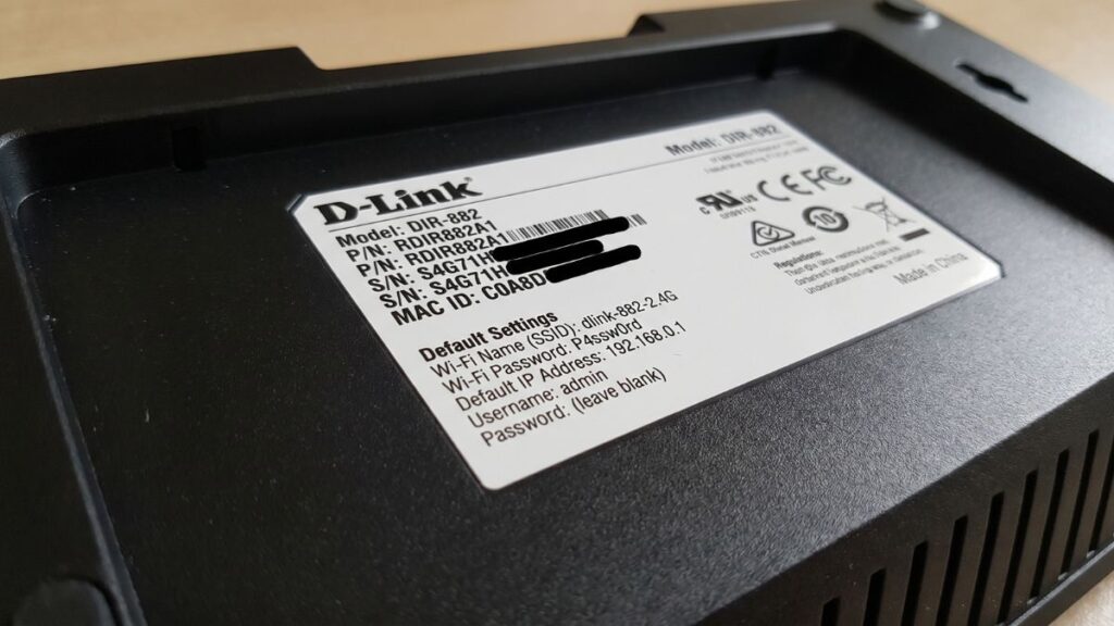 Bottom label of D-Link DIR-882 router showing default IP address, WiFi SSID, and admin login details