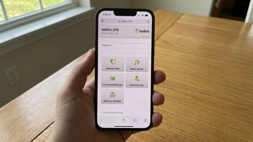 A hand holding a smartphone displaying the Belkin router login interface in a mobile browser web page, featuring a password input field and menu buttons for Website Filter, Connected Devices, and Guest Access.