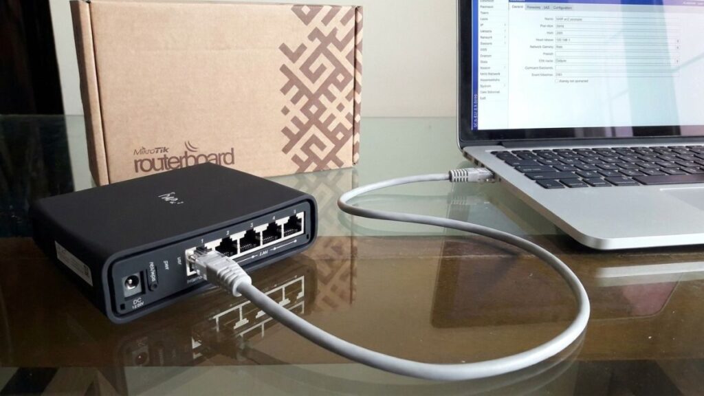 Router connected to laptop for router login and network configuration
