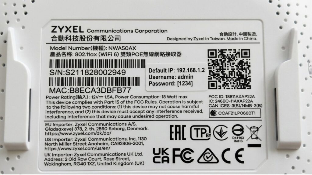 A close-up photograph of the product label sticker on a white Zyxel NWA50AX router, explicitly detailing the default IP address 192.168.1.2, username admin, and login password 1234.